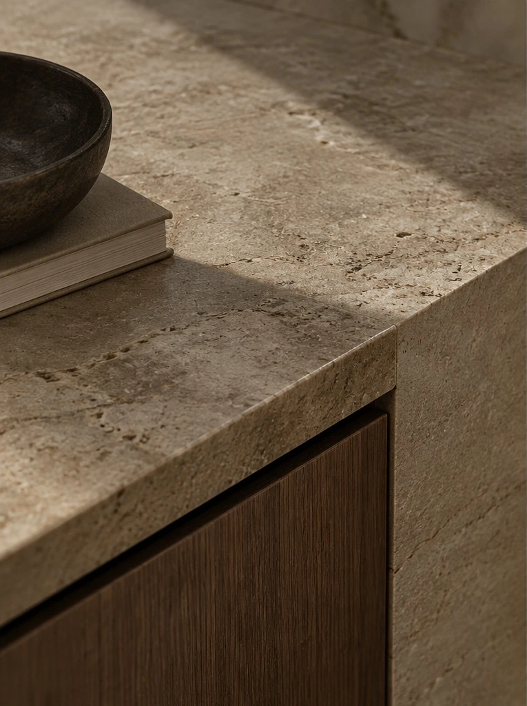 Close detail of honed stone and dark timber